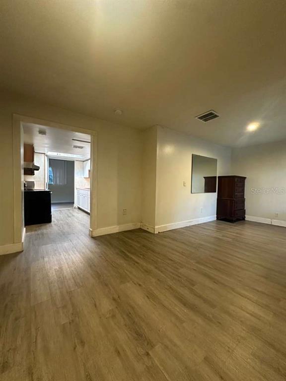 322 North Wekiwa Springs Road, Unit B Apopka, FL 32703 - Photo 4 of 15 a view of a livingroom with wooden floor and a kitchen