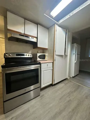 a kitchen with a stove microwave and refrigerator