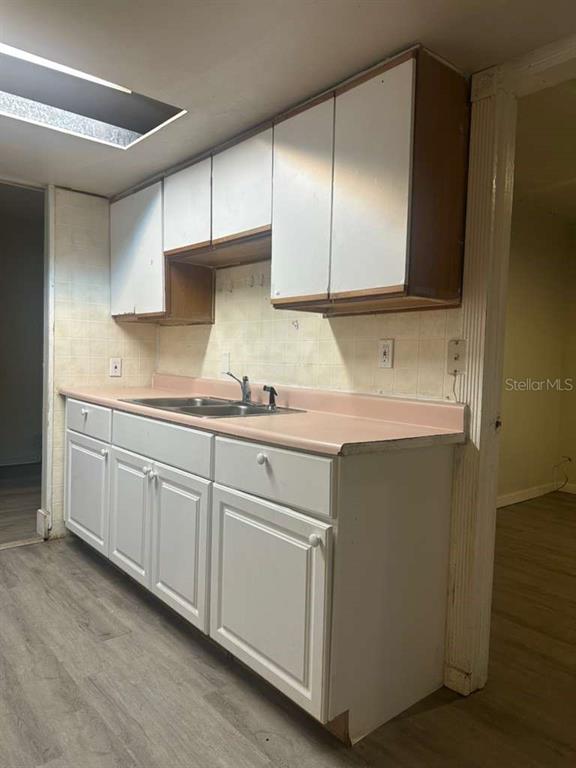 322 North Wekiwa Springs Road, Unit B Apopka, FL 32703 - Photo 6 of 15 a kitchen with cabinets and white appliances