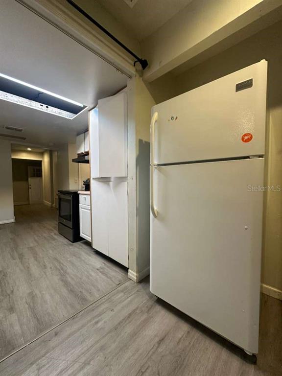 322 North Wekiwa Springs Road, Unit B Apopka, FL 32703 - Photo 7 of 15 a white refrigerator freezer sitting in a kitchen