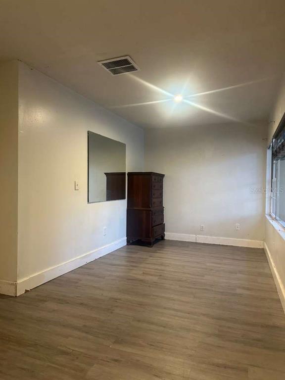 322 North Wekiwa Springs Road, Unit B Apopka, FL 32703 - Photo 9 of 15 a view of an empty room with wooden floor