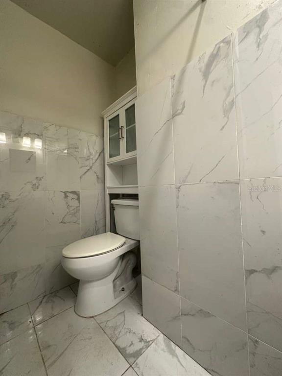 322 North Wekiwa Springs Road, Unit B Apopka, FL 32703 - Photo 10 of 15 a bathroom with a toilet and a shower