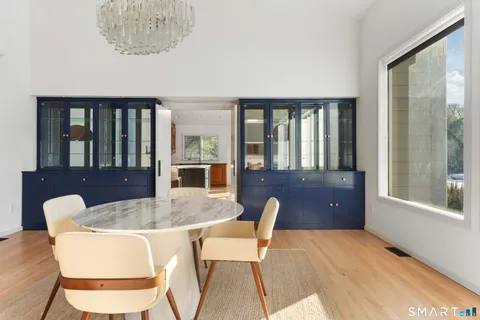 a bedroom with a bed wooden floor and window