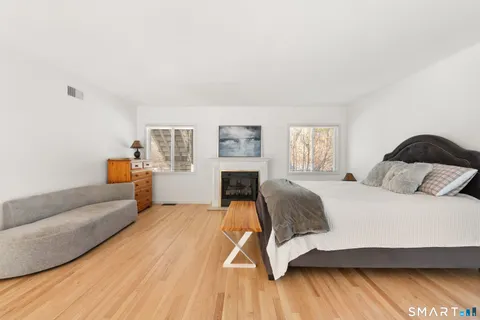 a spacious bedroom with a bed and a flat screen tv