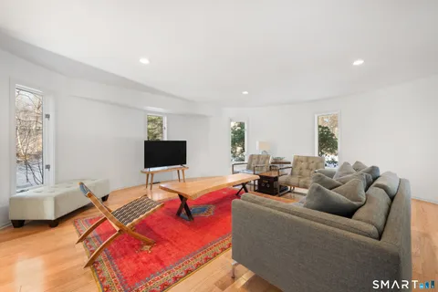 a dining room with furniture and wooden floor