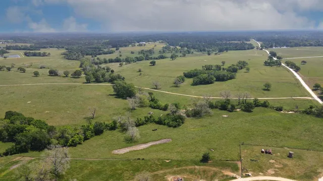 an aerial view of a houses with a yard