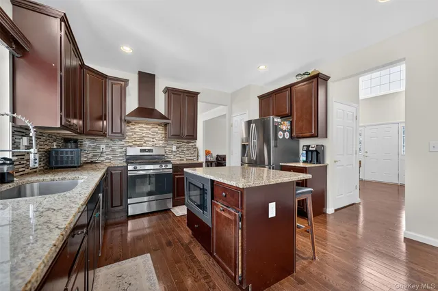 a kitchen with stainless steel appliances granite countertop a stove a sink dishwasher a refrigerator and a oven