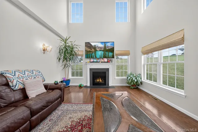 a living room with furniture large window and a fireplace