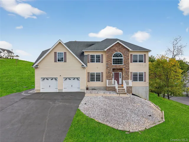 a front view of a house with a yard and garage