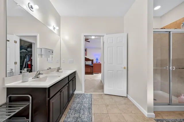 a bathroom with a double vanity sink and a mirror