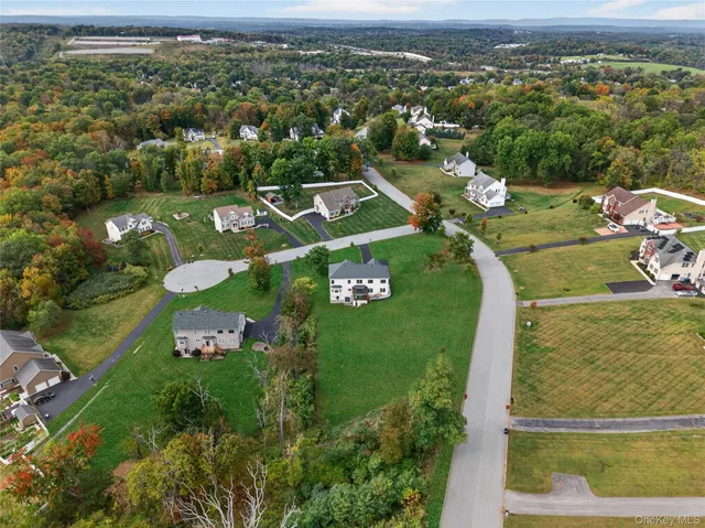 an aerial view of a golf course with parking space