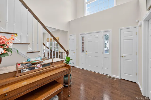 a sitting area with wooden floor and stairs