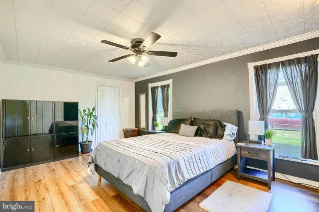 a bedroom with a bed and a view of balcony
