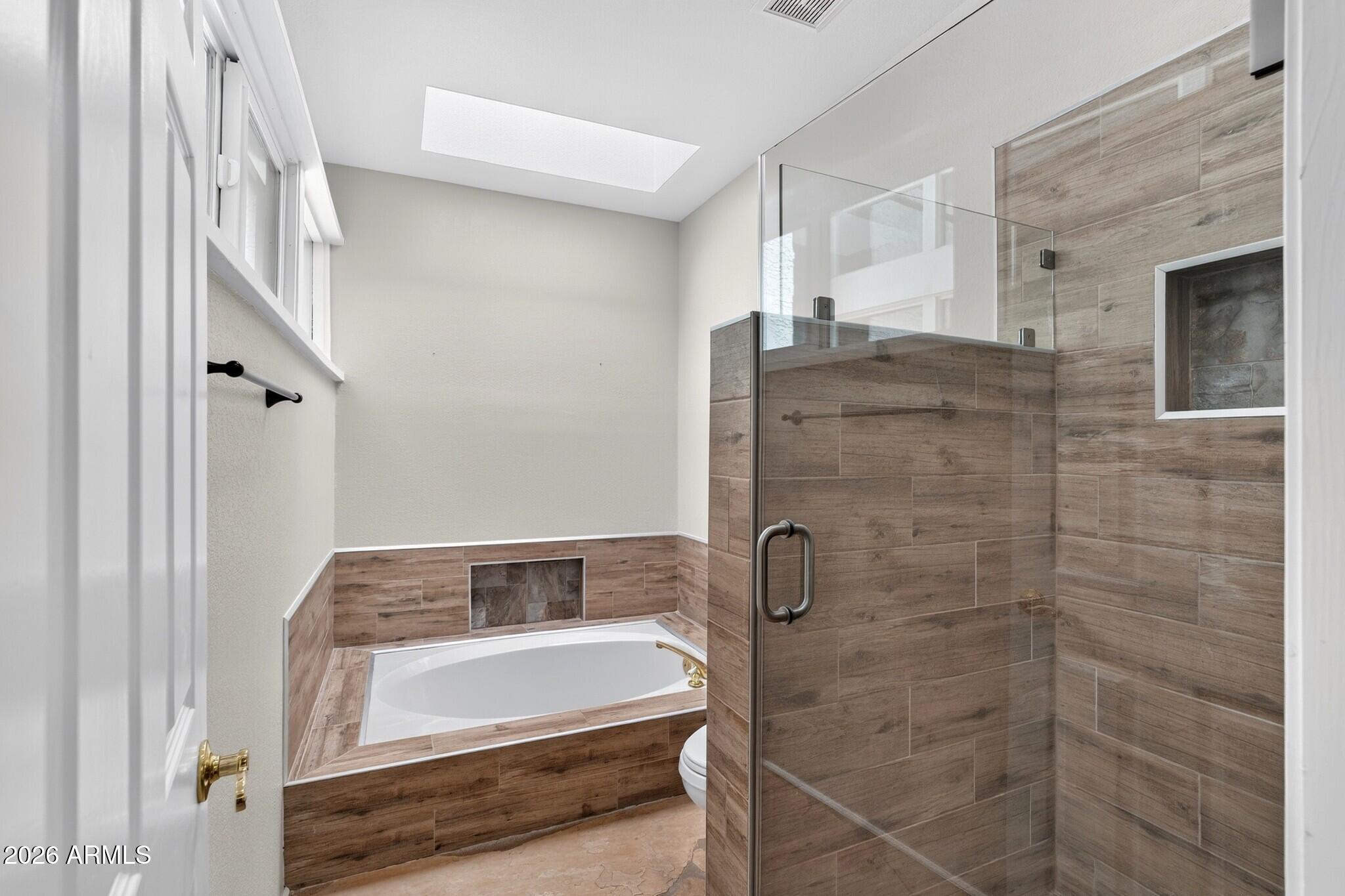 4615 East Monte Way Phoenix, AZ 85044 - Photo 16 of 35 a bathroom with a bathtub and a shower