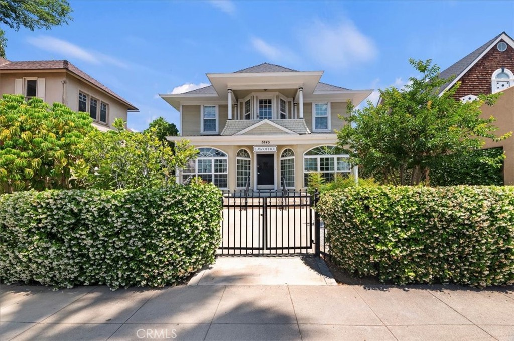 3845 Tenth Street Riverside, CA 92501 - Photo 2 of 45 a front view of a house with a garden