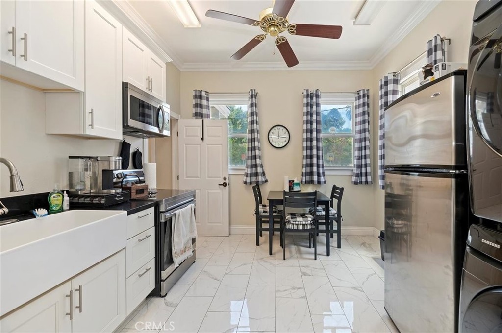 3845 Tenth Street Riverside, CA 92501 - Photo 22 of 45 a kitchen with stainless steel appliances kitchen island granite countertop a sink and cabinets