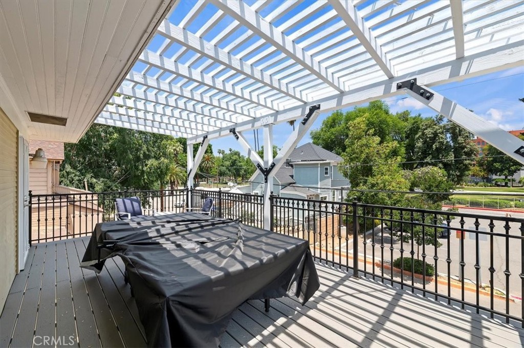 3845 Tenth Street Riverside, CA 92501 - Photo 36 of 45 a view of a roof deck with wooden floor and fence
