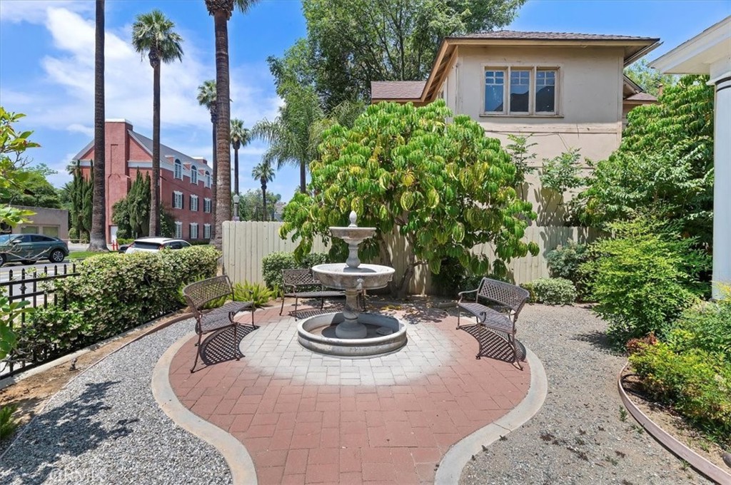 3845 Tenth Street Riverside, CA 92501 - Photo 7 of 45 a view of a backyard with table and chairs potted plants and palm tree