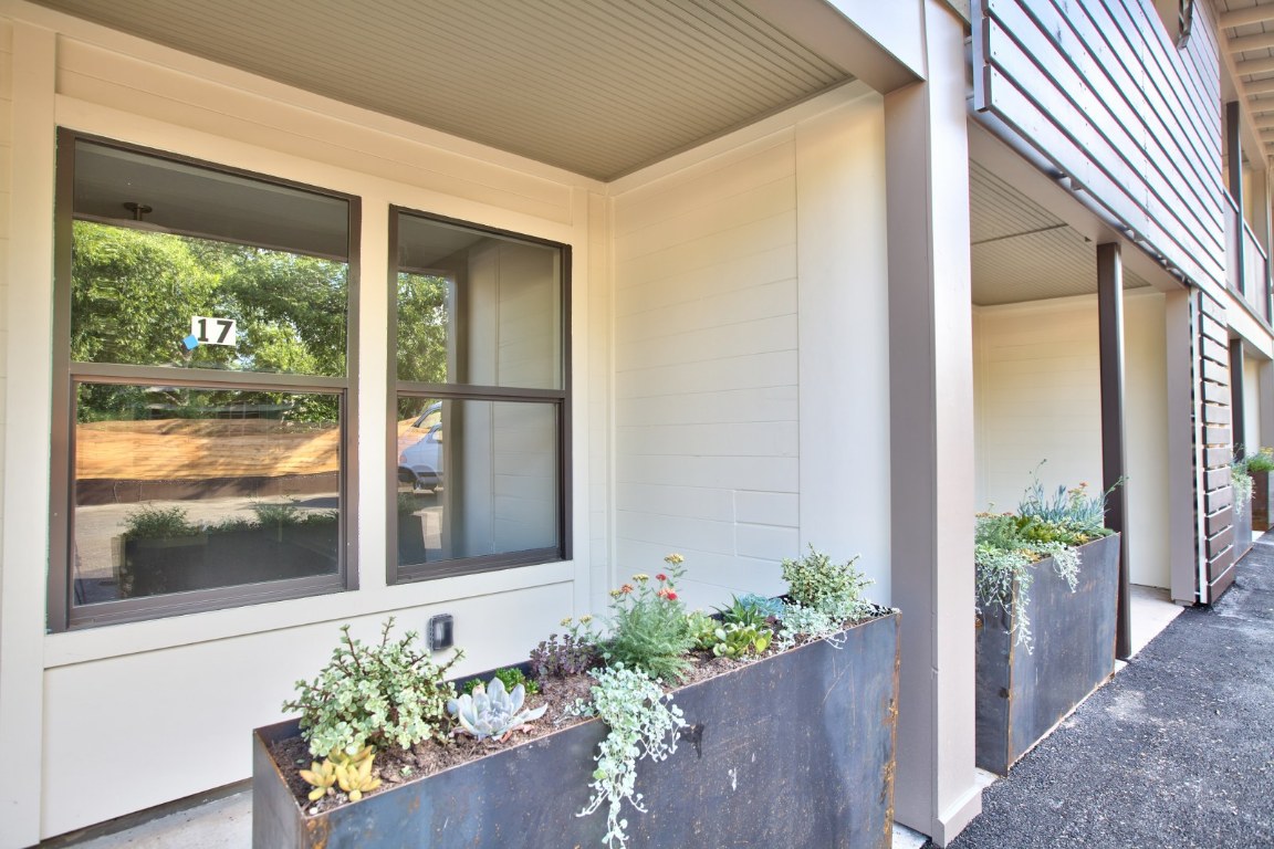 924 East 51st Street, Unit 108 Austin, TX 78751 - Photo 19 of 30 a front view of a house with a flower garden