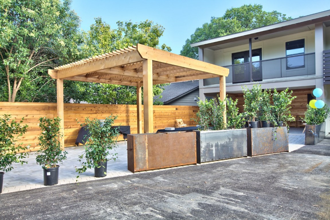 924 East 51st Street, Unit 108 Austin, TX 78751 - Photo 28 of 30 a backyard of a house with a yard and potted plants