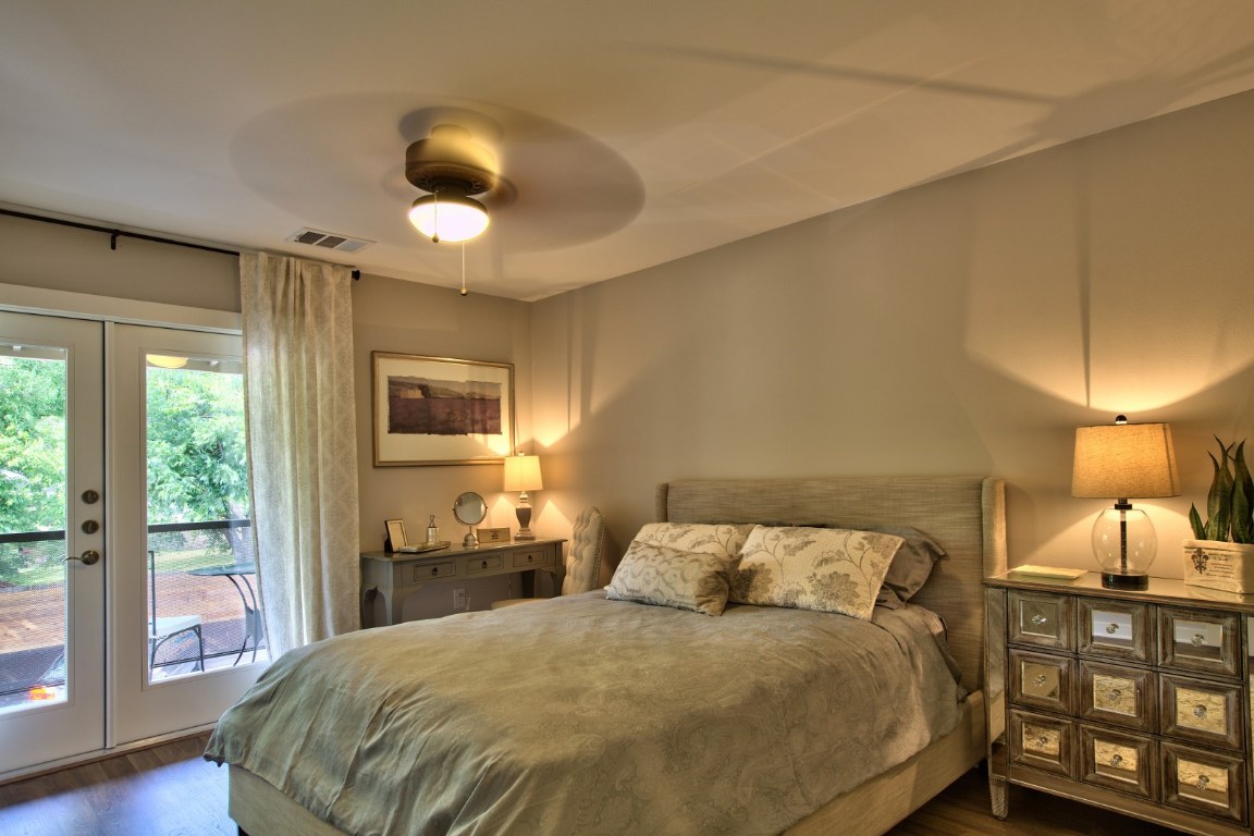 924 East 51st Street, Unit 108 Austin, TX 78751 - Photo 7 of 30 a bedroom with a bed and wooden floor