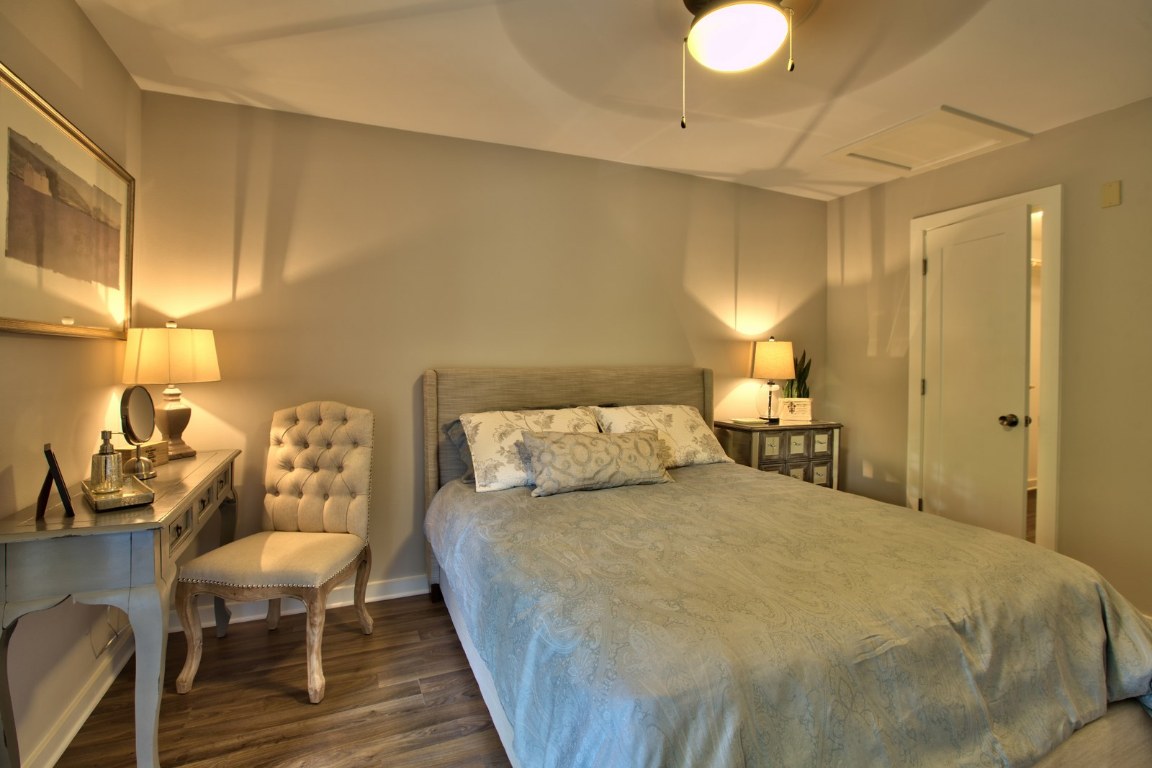 924 East 51st Street, Unit 108 Austin, TX 78751 - Photo 8 of 30 a bedroom with a bed and wooden floor