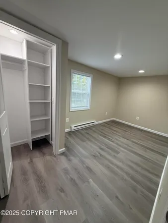 a view of walk in closet with empty racks