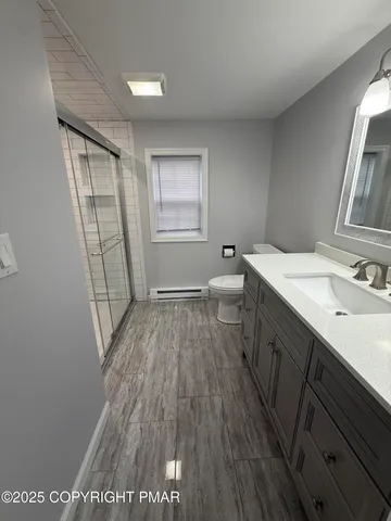 a bathroom with a glass shower door