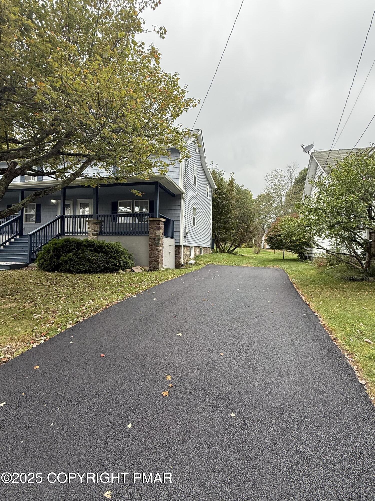 1114 Mill Street, Unit 2 Tobyhanna, PA 18466 - Photo 2 of 21 a view of a house with a yard and palm trees