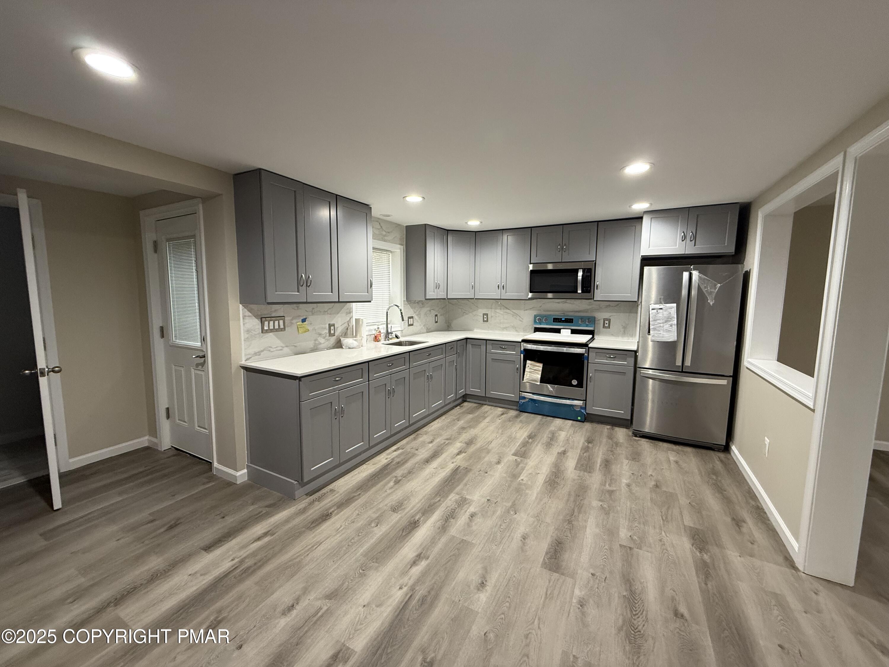 1114 Mill Street, Unit 2 Tobyhanna, PA 18466 - Photo 5 of 21 a kitchen with stainless steel appliances granite countertop a refrigerator sink and cabinets