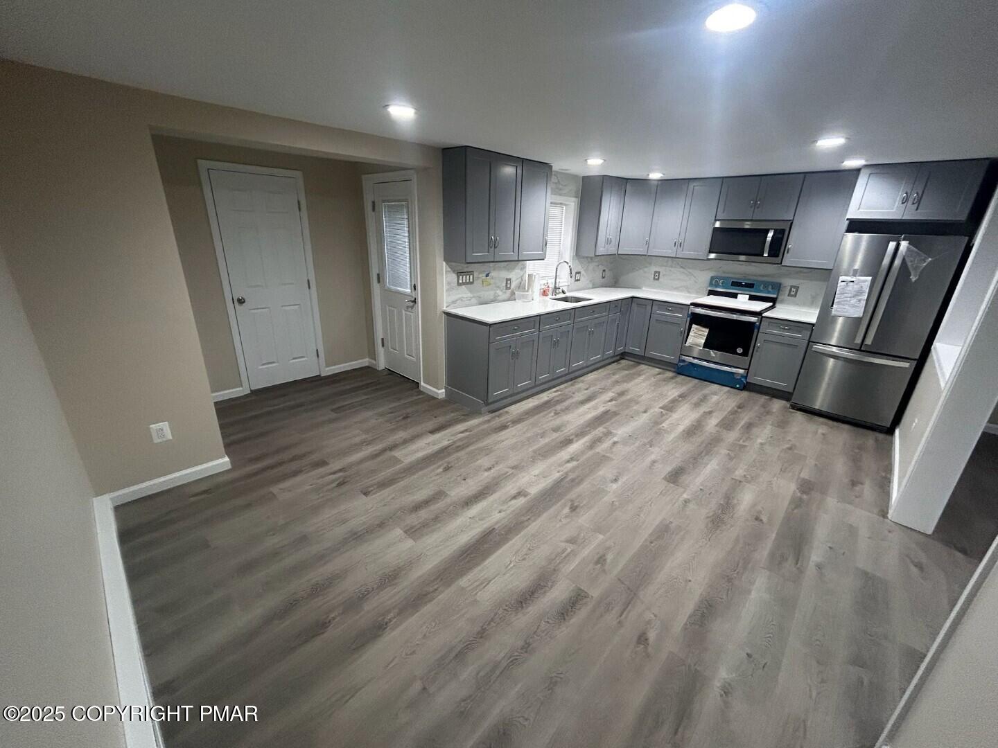 1114 Mill Street, Unit 2 Tobyhanna, PA 18466 - Photo 6 of 21 a kitchen with stainless steel appliances granite countertop a refrigerator sink and cabinets