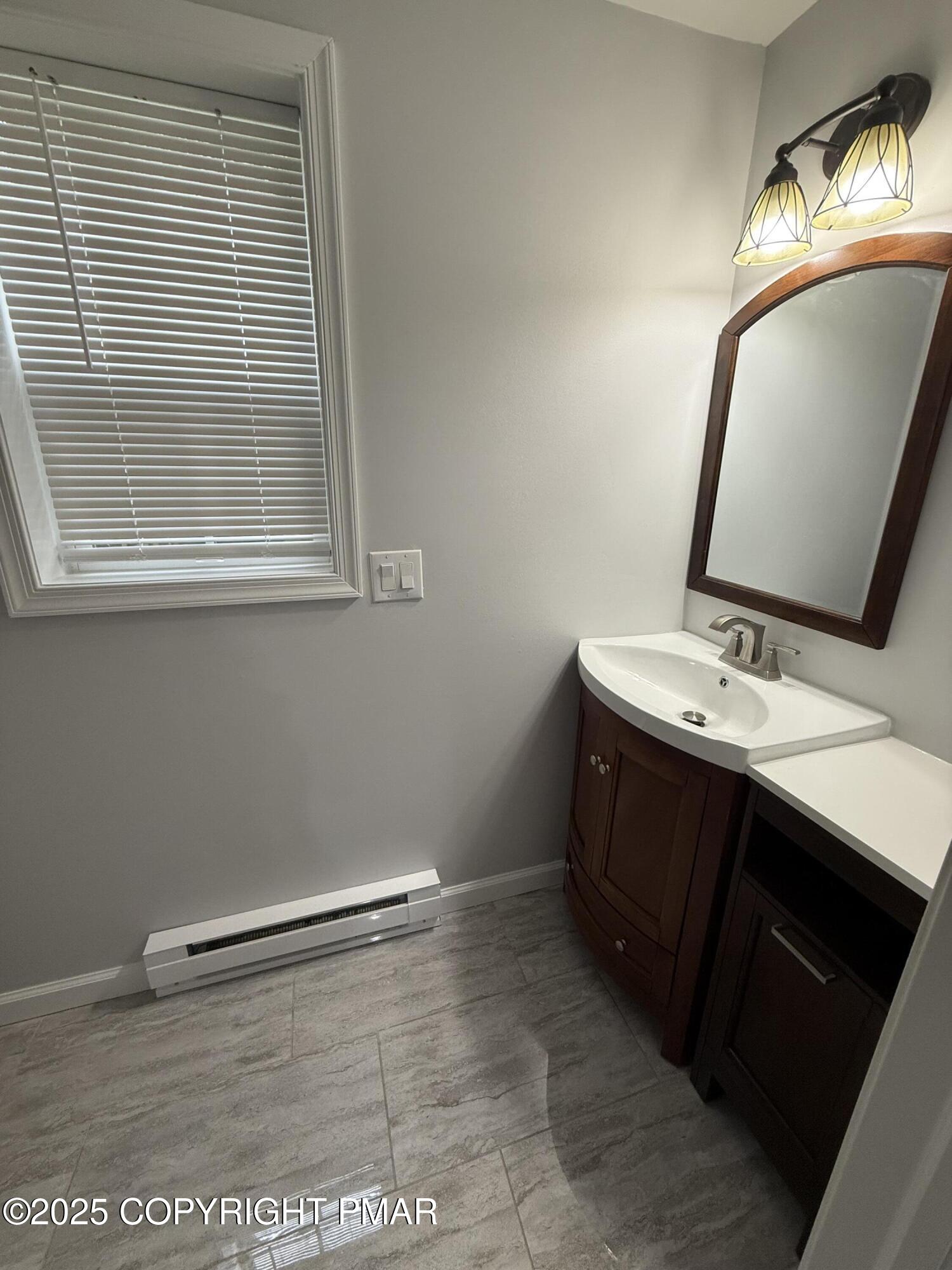 1114 Mill Street, Unit 2 Tobyhanna, PA 18466 - Photo 8 of 21 a bathroom with a sink vanity and a mirror
