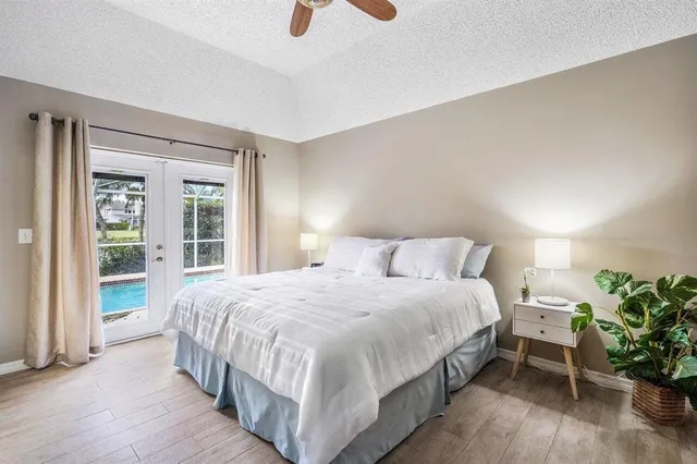 a spacious bedroom with a bed and a potted plant