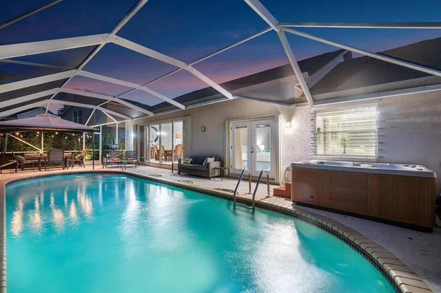 a view of swimming pool with outdoor seating