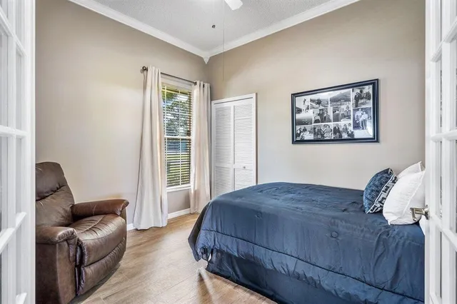 a bedroom with a bed couch and a window