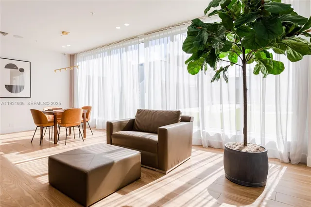 a living room with furniture and a potted plant