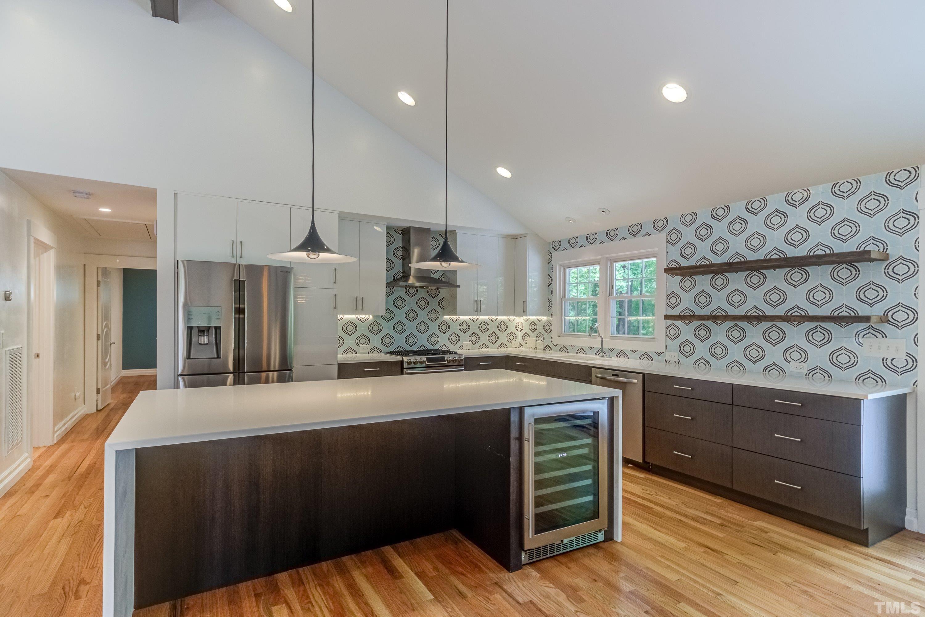 4221 Rowan Street Raleigh, NC 27609 - Photo 12 of 59 a kitchen with stainless steel appliances kitchen island granite countertop a sink and wooden cabinets