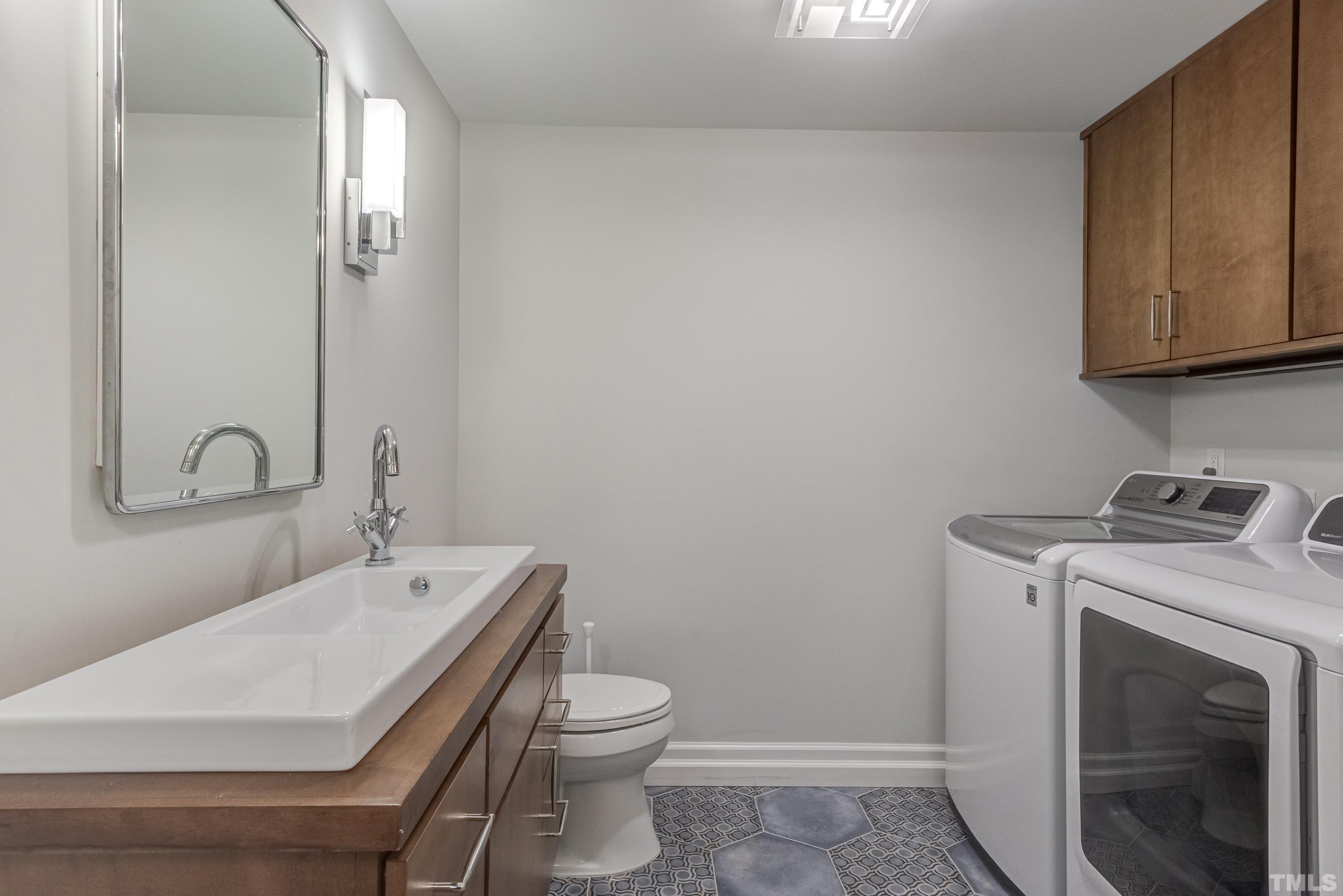 4221 Rowan Street Raleigh, NC 27609 - Photo 48 of 59 a bathroom with a sink a toilet and mirror