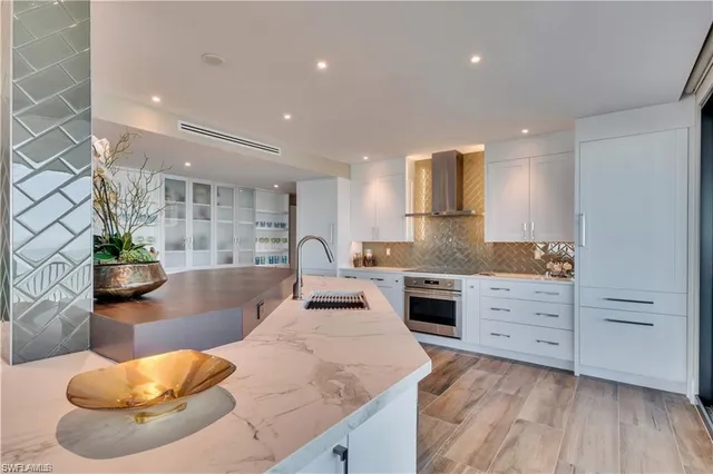 a living room with kitchen island furniture and a large window