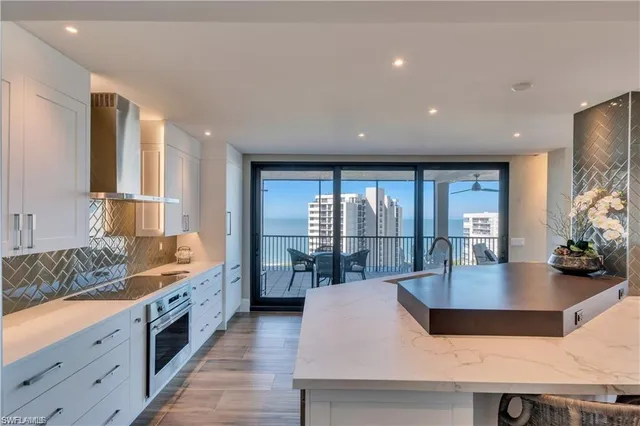 a kitchen with a table chairs sink and wooden floor