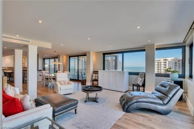 a dining room with furniture a chandelier and wooden floor