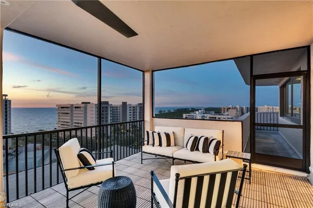 a living room with fireplace furniture and a large window