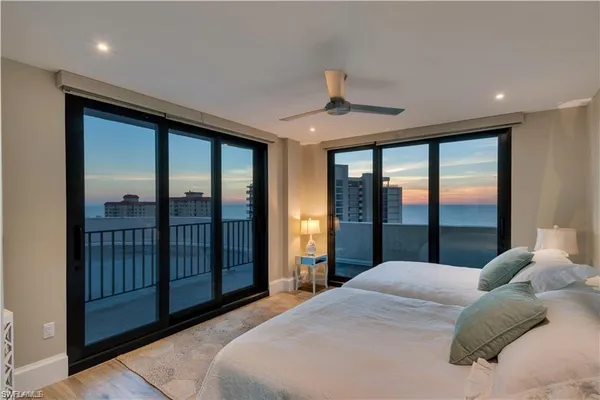 a large bedroom with a large bed and a large window