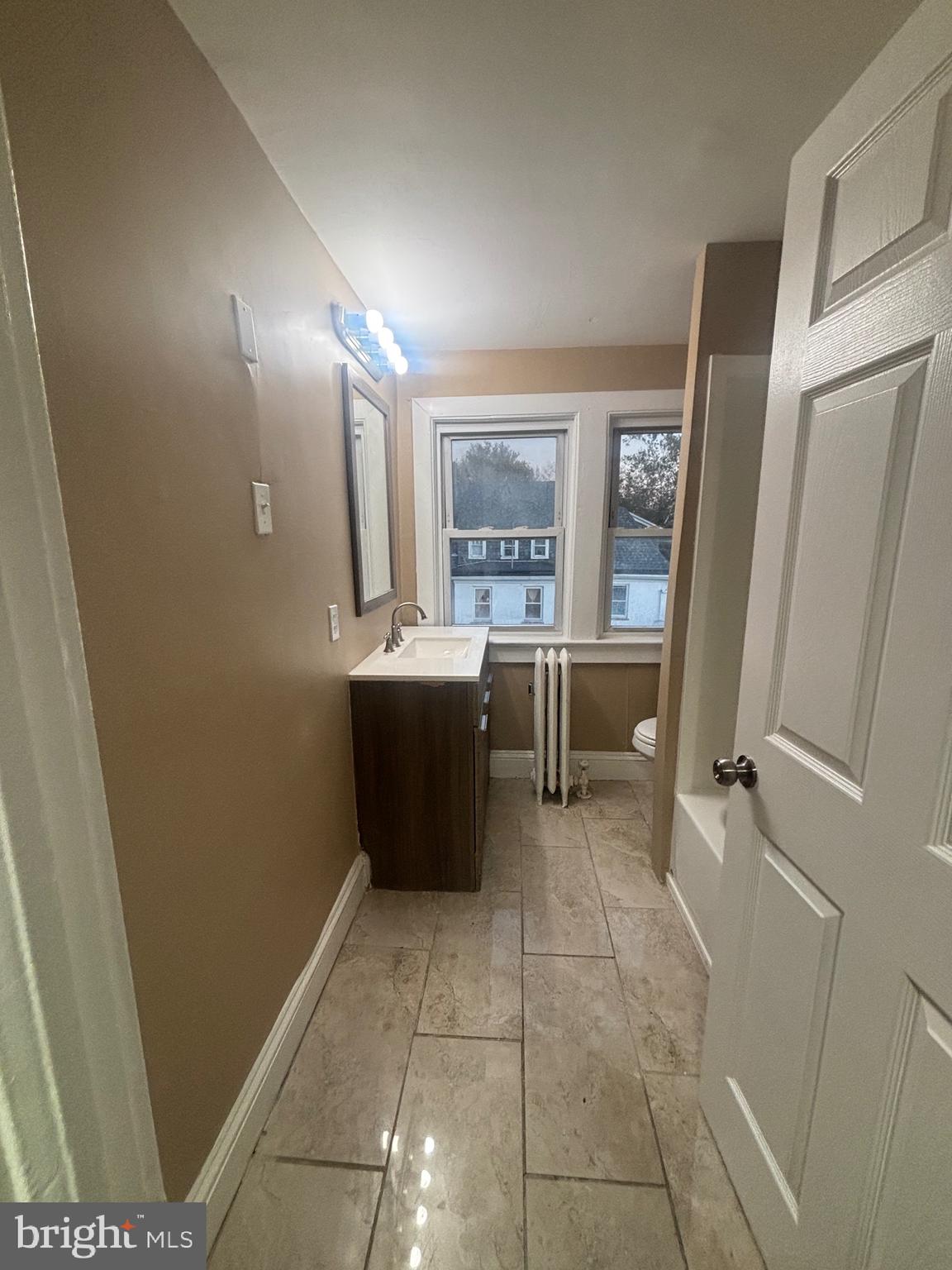 1428 West State Street Trenton, NJ 08618 - Photo 23 of 26 a room with a wooden floor and furniture