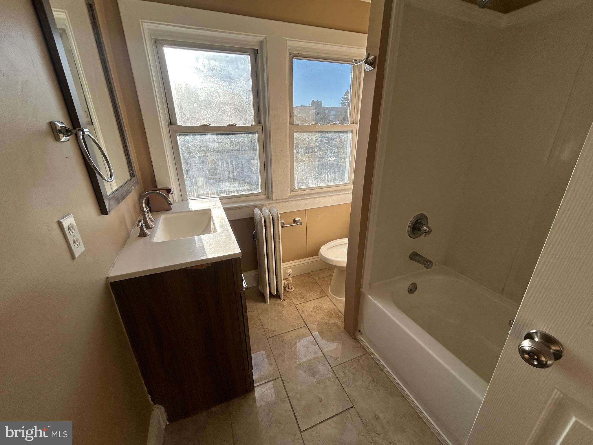 1428 West State Street Trenton, NJ 08618 - Photo 24 of 26 a bathroom with a sink a toilet and a bathtub