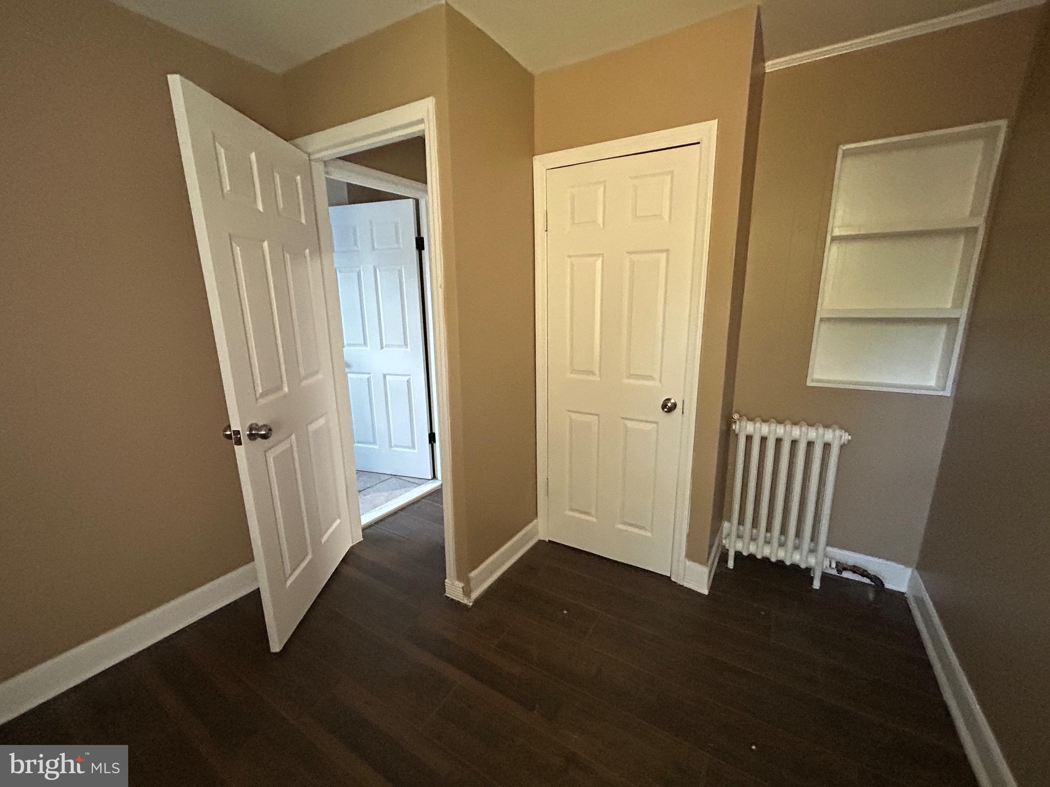 1428 West State Street Trenton, NJ 08618 - Photo 7 of 26 an empty room with wooden floor and a door