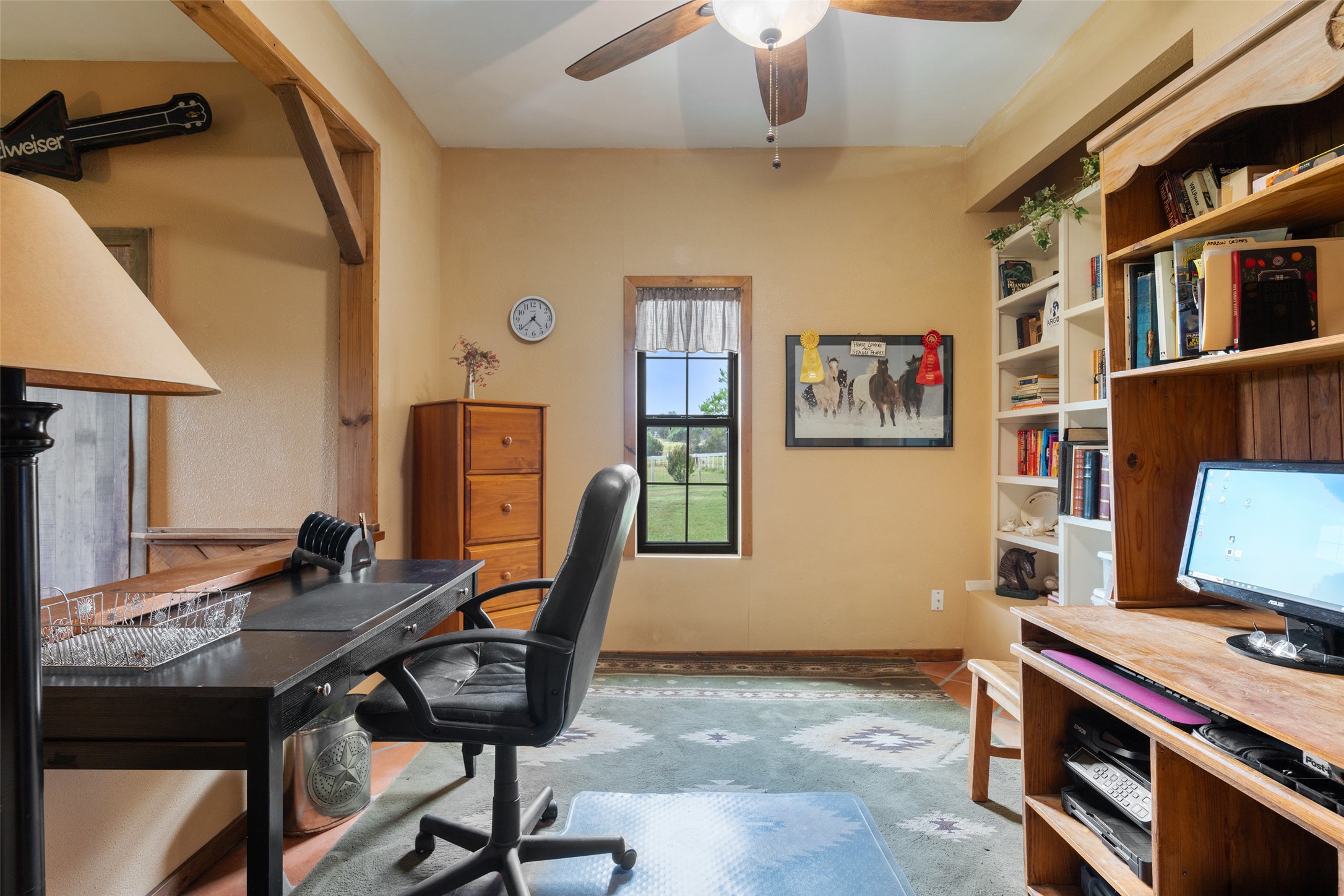 23200 Fulkes Road Leander, TX 78641 - Photo 3 of 15 A dedicated home office provides ample space for productivity with built-in shelving and a view of the surrounding landscape.
