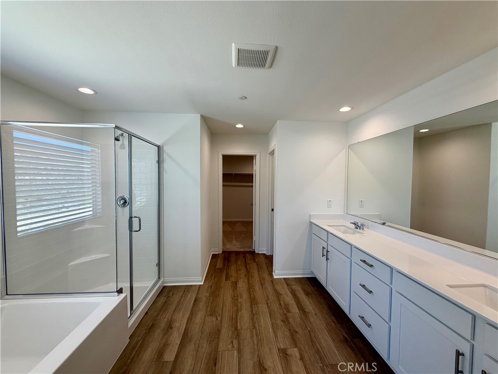 21624 Thomas Court Riverside, CA 92507 - Photo 21 of 36 a large bathroom with a double vanity sink and mirror