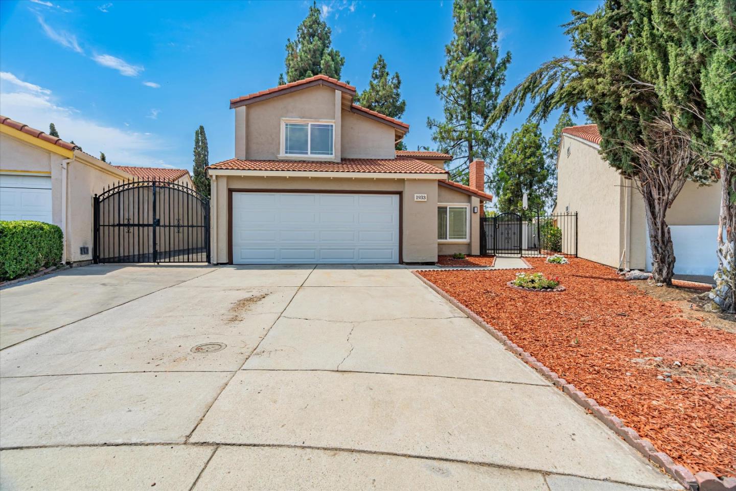 1933 Edgestone Circle San Jose, CA 95122 - Photo 3 of 40 a front view of a house with a yard and garage