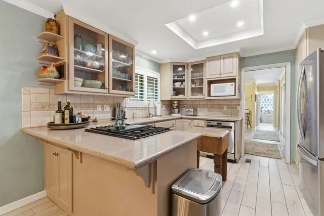 a kitchen with stainless steel appliances granite countertop a stove and a sink